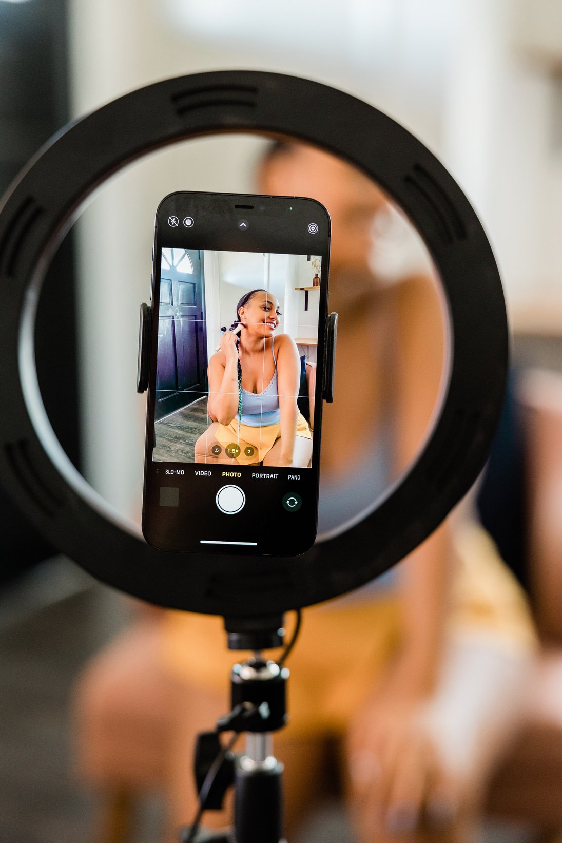 Woman Recording Herself on Smartphone While Applying Makeup