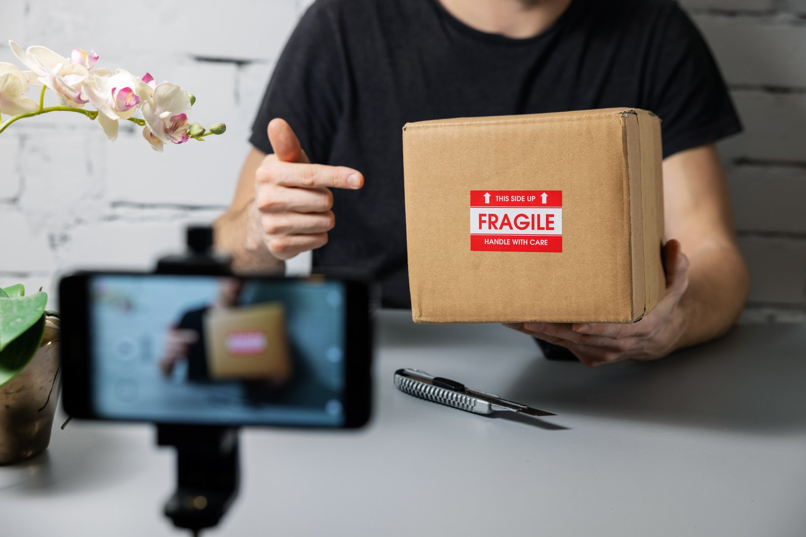 social media influencer recording product unboxing video. online marketing